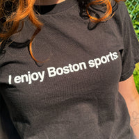 woman wearing women's black t-shirt with the words i enjoy boston sports in white simple text.
