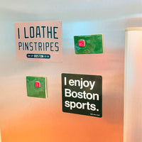 Fridge with decorative magnets including 'I loathe pinstripes' and 'I enjoy Boston sports.' from The Red Seat