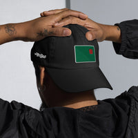 photo of a man wearing a backwards black baseball cap with fenway park's red seat embroidered on the front in green and red.