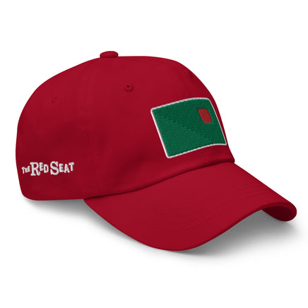 photo of a red baseball cap with fenway park's red seat embroidered on the front in green and red.