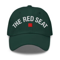 Front view of green dad cap with “The Red Seat” embroidered in white and red icon