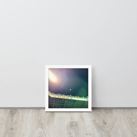 photo of right field fenway park at night with retired red sox numbers in a white frame