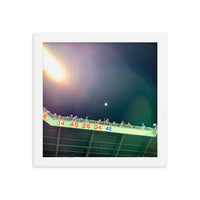 photo of right field fenway park at night with retired red sox numbers in a white frame