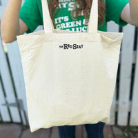 backside of tan canvas tote bag by the red seat