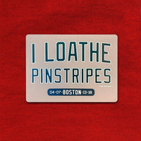 Refrigerator magnet with text 'I LOATHE PINSTRIPES' on a red background