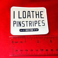 photo of medium waterproof vinyl sticker of I Loathe Pinstripes-The Red Seat grey design with boston world series wins Yankees Suck with a ruler on red background