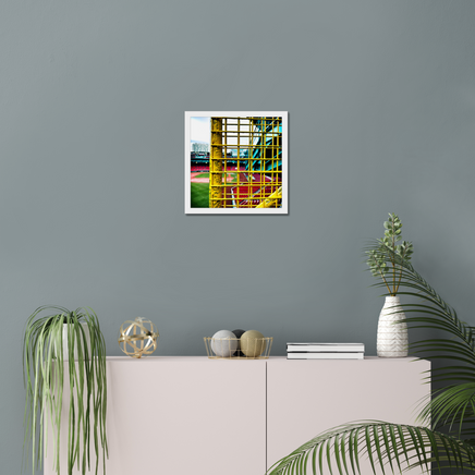 color photograph of fenway park through the yellow left field foul pole, in a white frame