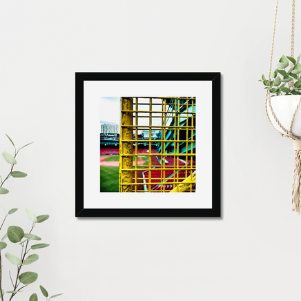 color photograph of fenway park through the yellow left field foul pole, in a black frame