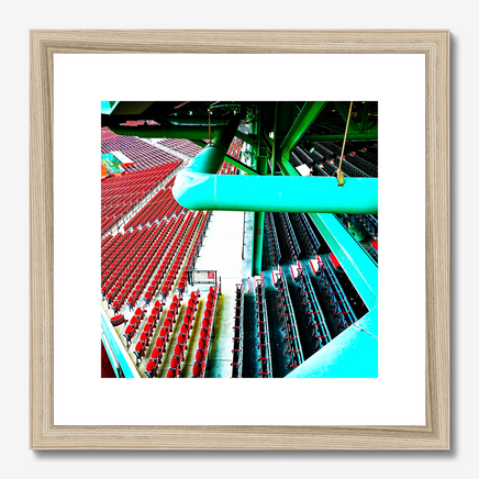 photo of fenway parks left field grandstand and field boxes in red and blue with the green metal structure of the building, matted in a wood frame