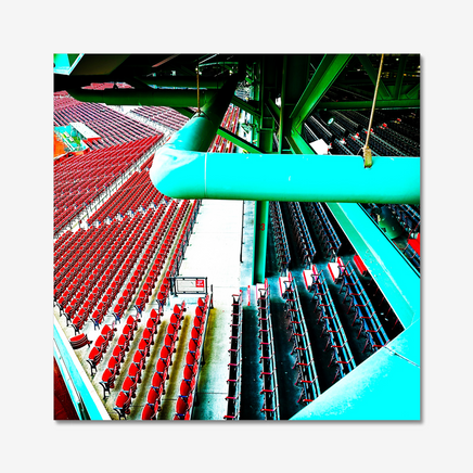 photo of fenway parks left field grandstand and field boxes in red and blue with the green metal structure of the building