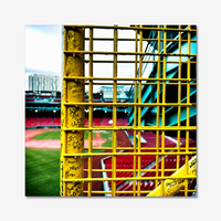 color photograph of fenway park through the yellow left field foul pole, on a wall