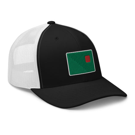 photograph of a black trucker with white mesh with fenway park's red seat on a green background