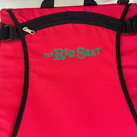 close up photo of red portable cushioned stadium seat with the red seat logo in green
