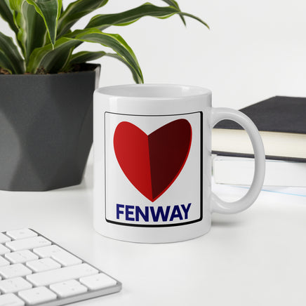 white ceramic mug with the boston fenway citgo sign in the shape of a heart in an office
