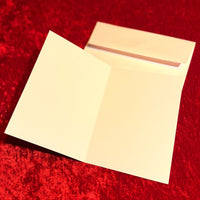 blank card and envelope on a red textured background