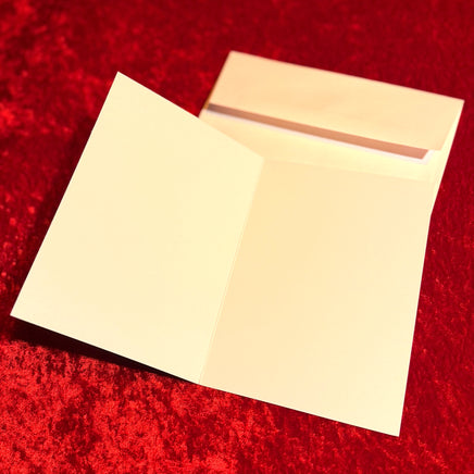 blank card and envelope on a red textured background