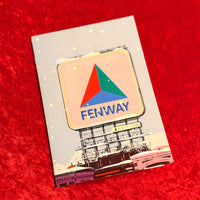 Card with Fenway Park Citgo Sign on a red surface