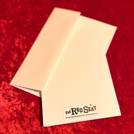 back of holiday card 'The Red Seat' logo on a red textured background