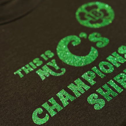 close up Black unisex t-shirt with the words this is my C's championship shirt in glittery green lettering