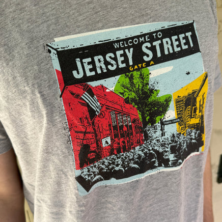close up photo of man wearing  light grey t-shirt with boston red sox fenway park jersey street gate a design with blocks of color