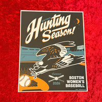 A rectangular printed poster or art print laid on a red textured surface. The design reads 'Hunting Season!' with 'Boston's' above it, featuring an illustrated eagle, baseball, crossed bats, and the text 'Boston Women's Baseball' and 'Summer 2026'.