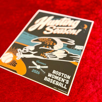 A rectangular printed poster or card with a white border lies on a textured red surface. The design features the words 'Hunting Season!' in large white script, an eagle illustration, a baseball, and the text 'BOSTON WOMEN'S BASEBALL 2026'.