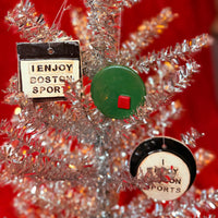 Decorative Christmas tree with ornaments featuring 'I Enjoy Boston Sports' on a red background