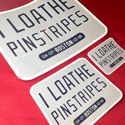 photo of 3 sizes of waterproof vinyl sticker of I Loathe Pinstripes-The Red Seat grey design with boston world series wins Yankees Suck with a ruler on red background