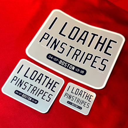 photo of 3 sizes of waterproof vinyl sticker of I Loathe Pinstripes-The Red Seat grey design with boston world series wins Yankees Suck with a ruler on red background