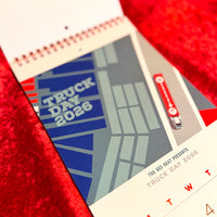 Calendar with 'Truck Day 2026' design on a red textured background