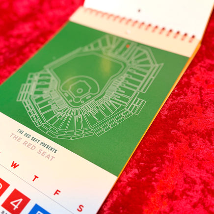 Calendar with a baseball stadium design on a red textured background