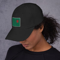 photo of a woman wearing a black baseball cap with fenway park's red seat embroidered on the front in green and red.