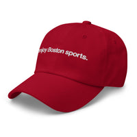 side view of red baseball cap with "i enjoy boston sports" embroidered in white helvetica font