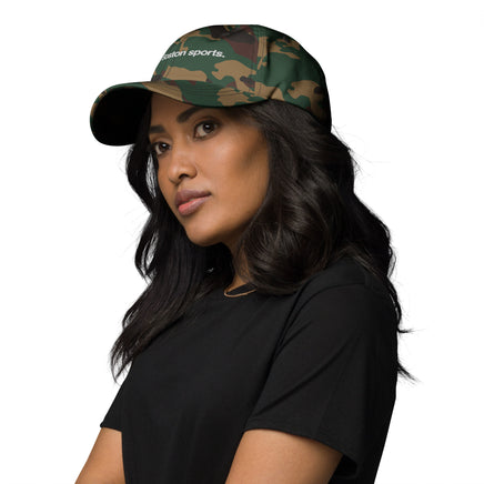 woman wearing camo baseball cap with "i enjoy boston sports" embroidered in white helvetica font