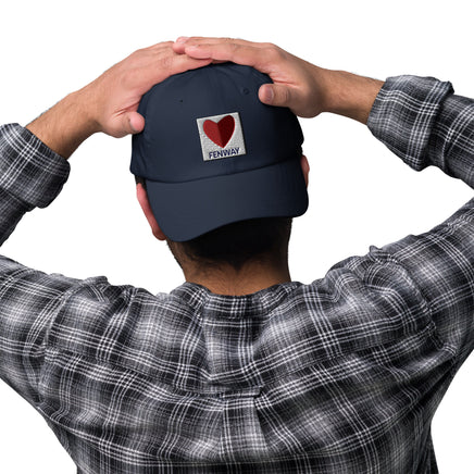 graphic of the citgo sign boston fenway as a heart embroidered on baseball hat, worn backwards on mans head