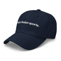 side view of navy baseball cap with "i enjoy boston sports" embroidered in white helvetica font