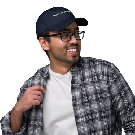 man wearing navy baseball hat with the red seat logo