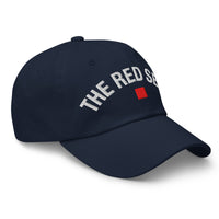 side view of navy dad cap with “The Red Seat” embroidered in white and red icon