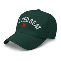side view of green dad cap with “The Red Seat” embroidered in white and red icon