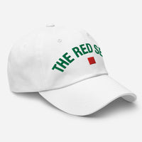 White cap with green text and red square logo on a white background