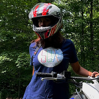 photo of a woman on a motorcycle wearing boston MBTA red sox the t t-shirt the red seat