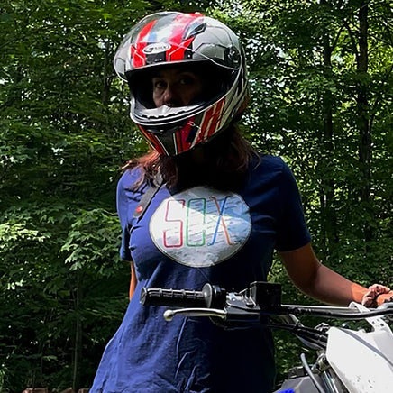 photo of a woman on a motorcycle wearing boston MBTA red sox the t t-shirt the red seat