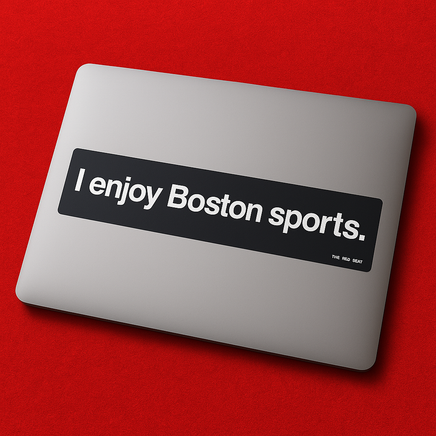 Laptop with a sticker reading 'I enjoy Boston sports' on a red background