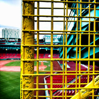 color photograph of fenway park through the yellow left field foul pole