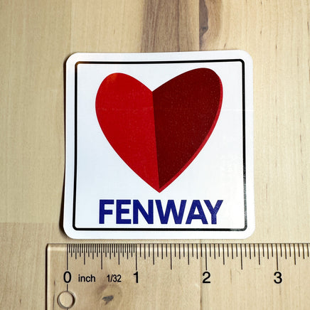 photo of a square vinyl sticker with the word FENWAY and a heart in the style of the boston citgo sign with a ruler