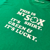 close up photo of green unisex t-shirt from the red seat with white text that says "this is my sox shirt. it's green and it's lucky" on the front.