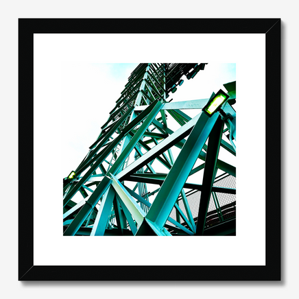photograph of a boston red sox fenway park light tower looking up with green metal and a light sky, on a wall in a black frame