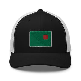 photograph of a black trucker with white mesh with fenway park's red seat on a green background