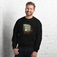 photo of man wearing Monster Seats-The Red Seat Design with the words Monster Seats painted on a wall fenway park boston on black crewneck sweatshirt