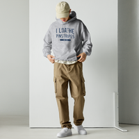 photo of a man wearing a grey hoodie with the words I Loathe Pinstripes on it